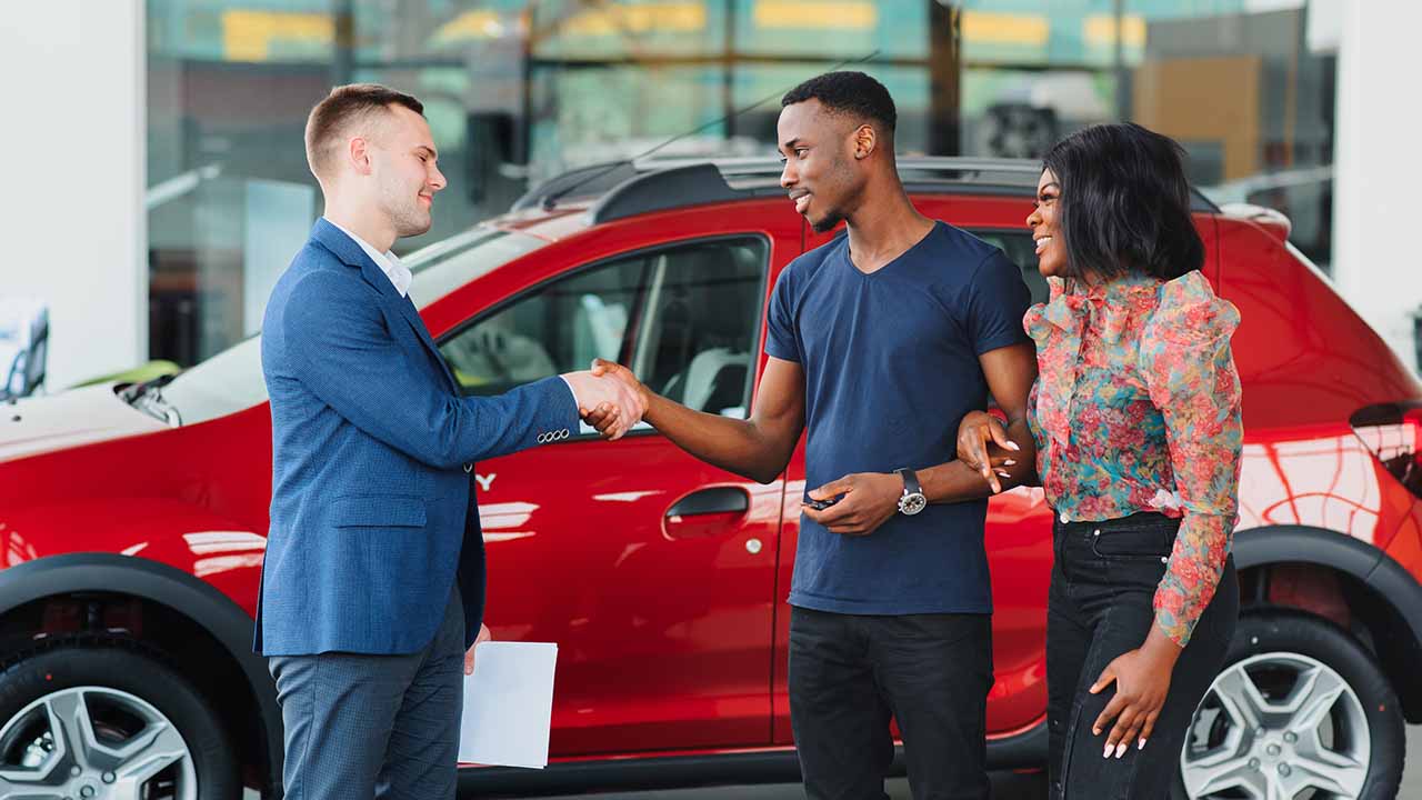 Couple Buying a Car From a Dealer