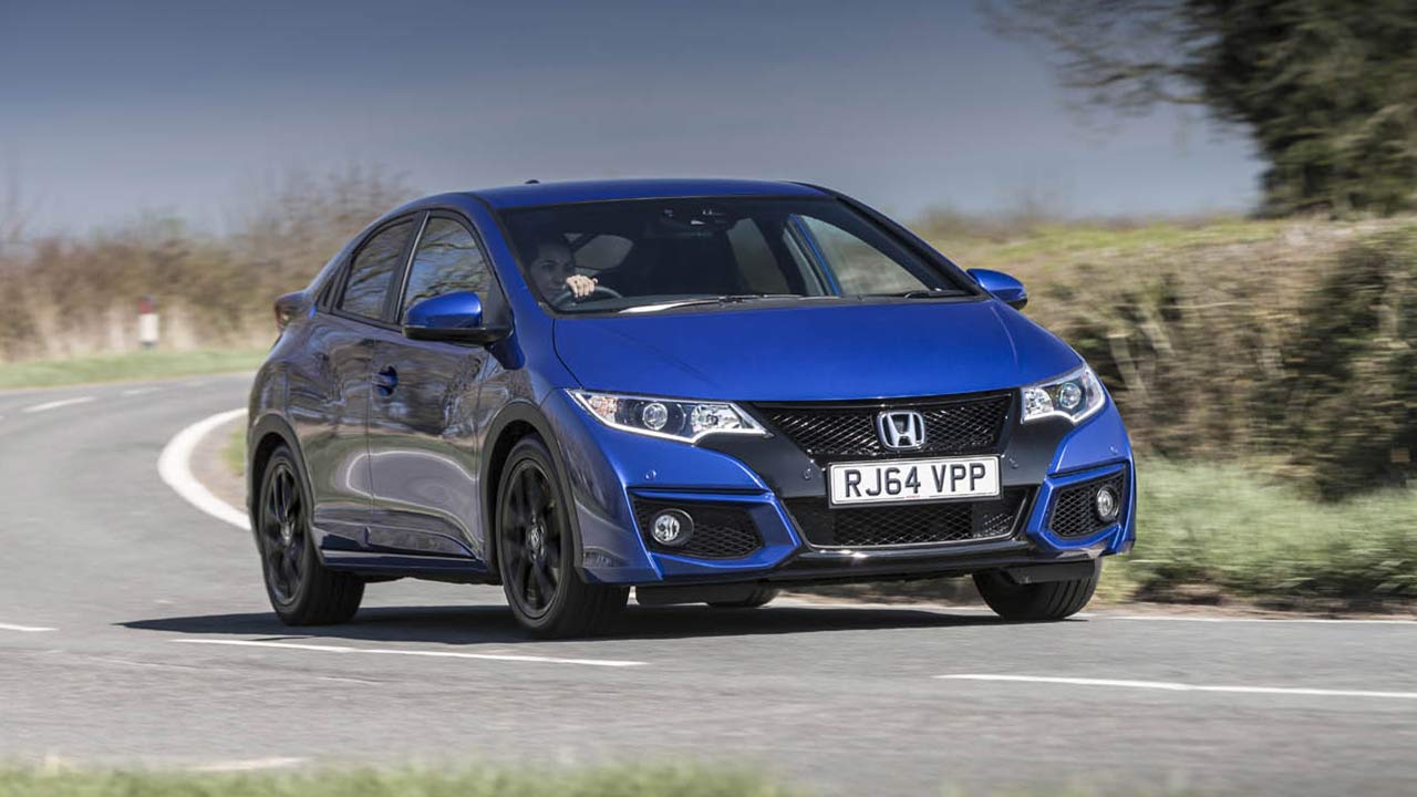 Blue Honda Civic driving down a country road