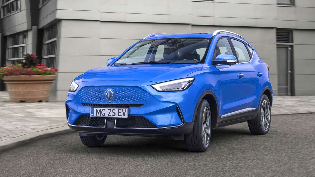 Blue MG ZS EV driving down a city street