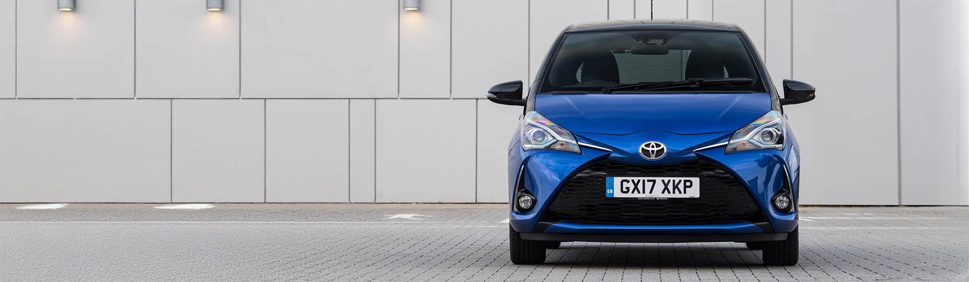 Head on shot of a blue Toyota Yaris