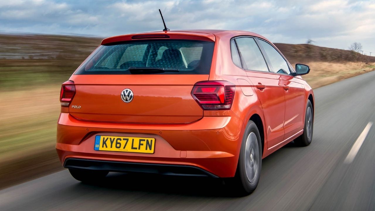 Rear end of an orange Volkswagen Polo driving in the motorway