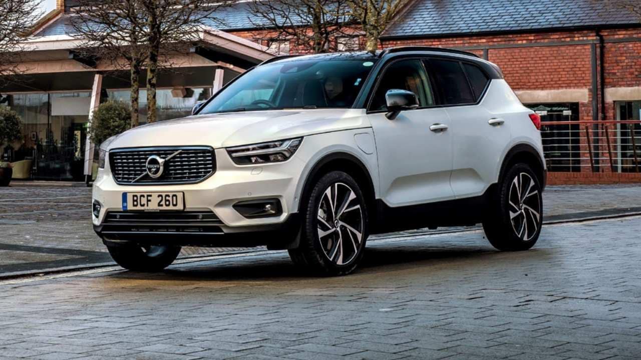 White Volvo XC40 parked in front of a red brick building