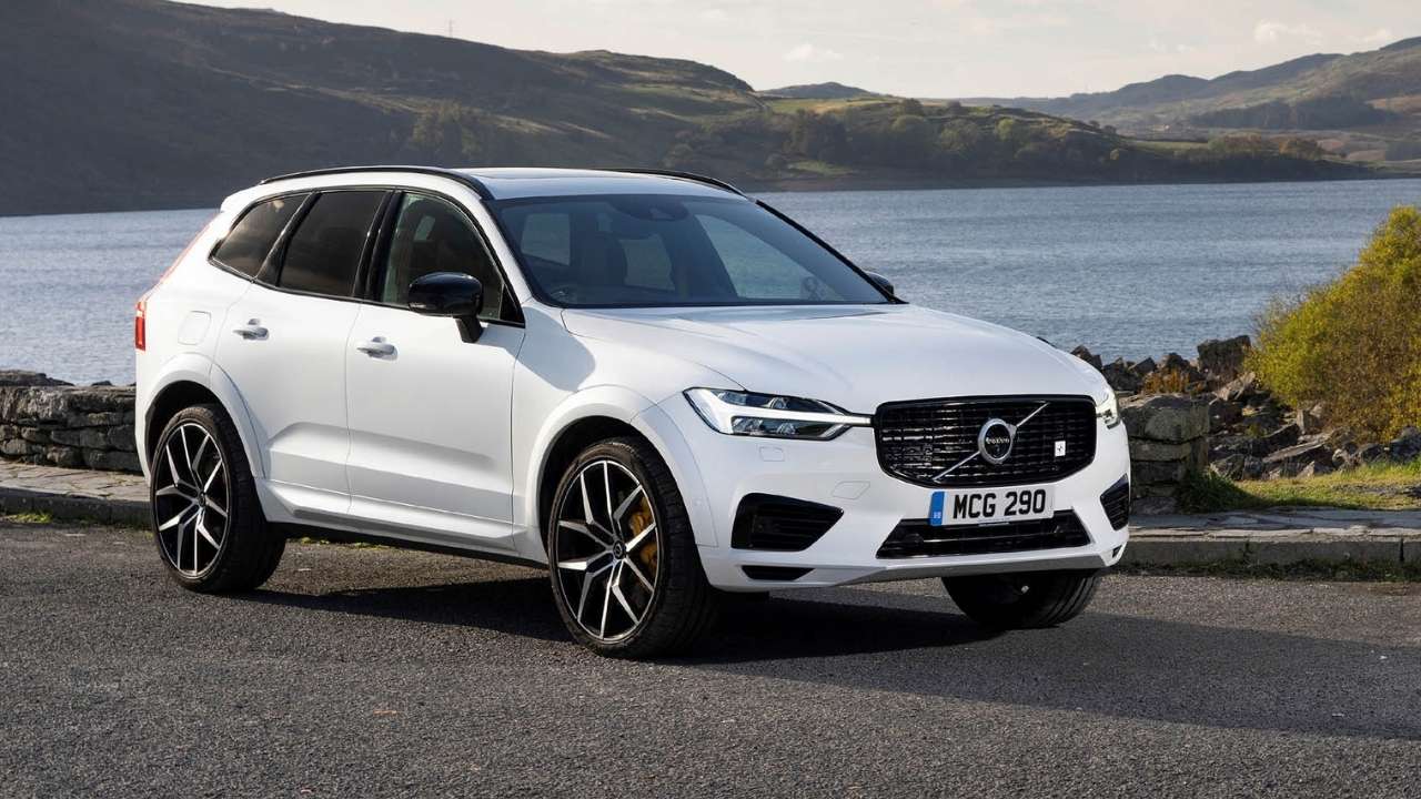 White Volvo XC60 parked in front of the ocean